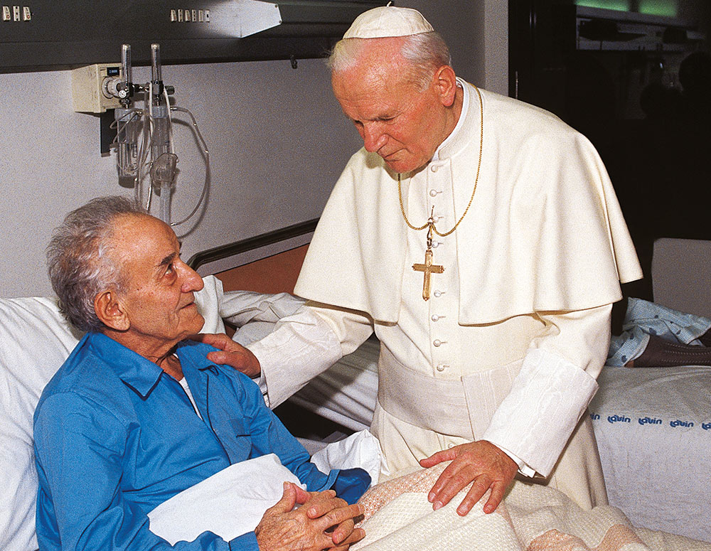 Pope John Paul II visits a patient at the Figlie di San Camillo Hospital in Rome.