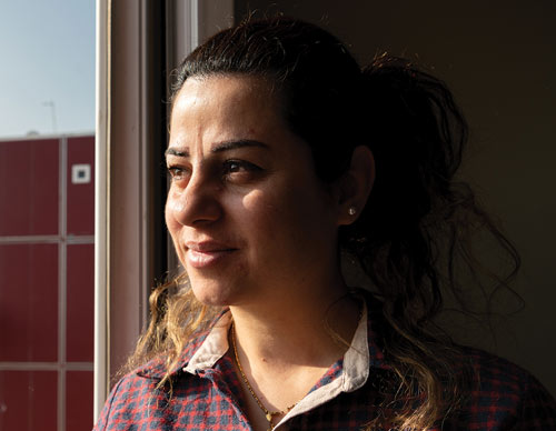 Nahrain Samir Shamoun looks out from her family’s new apartment