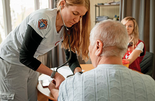 Dr. Doris Schulz, a physician from Argentina, treats a patient at the STEP-IN clinic in Dnipro, Ukraine, April 25.