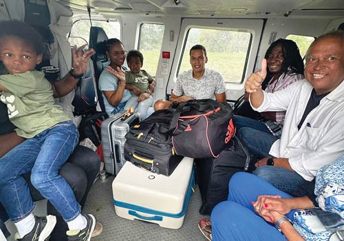A group of people sit in Marinello&rsquo;s helicopter after being evacuated from Port-au-Prince on April 14, Marinello and Matos&rsquo; final day flying rescue missions. (Photo courtesy of Anthony Marinello)