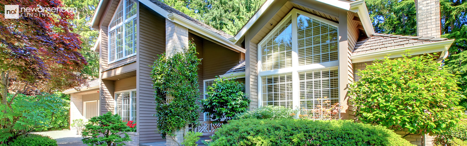 A nice vinyl sided home surrounded by trees and plants