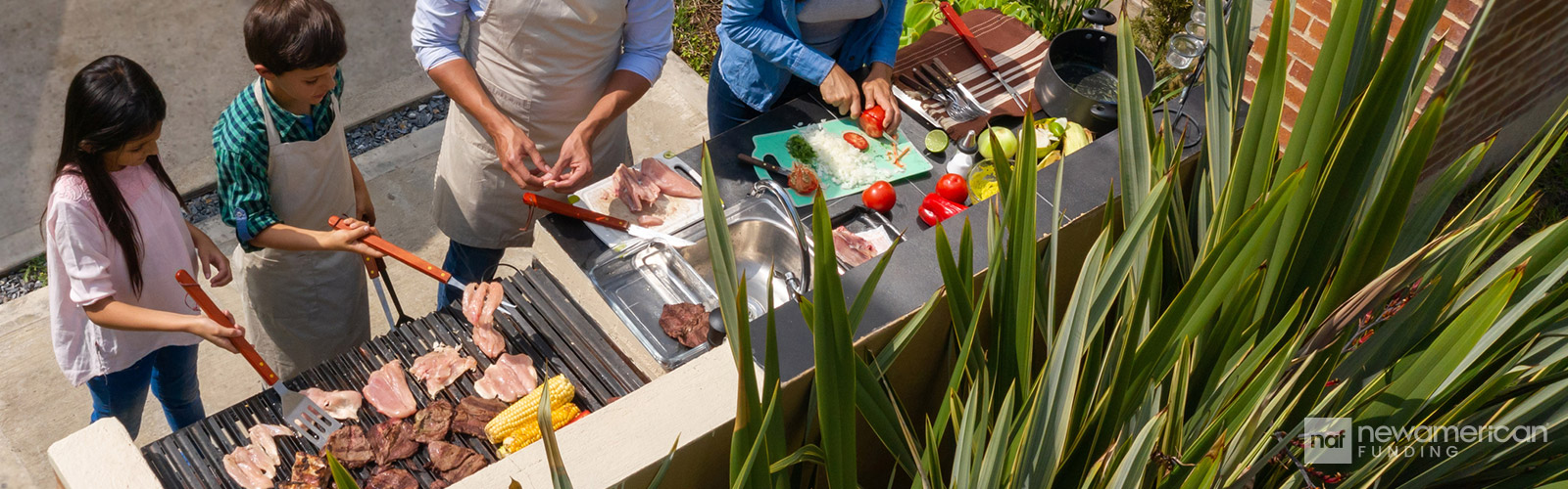 family cooking in outdoor kitchen