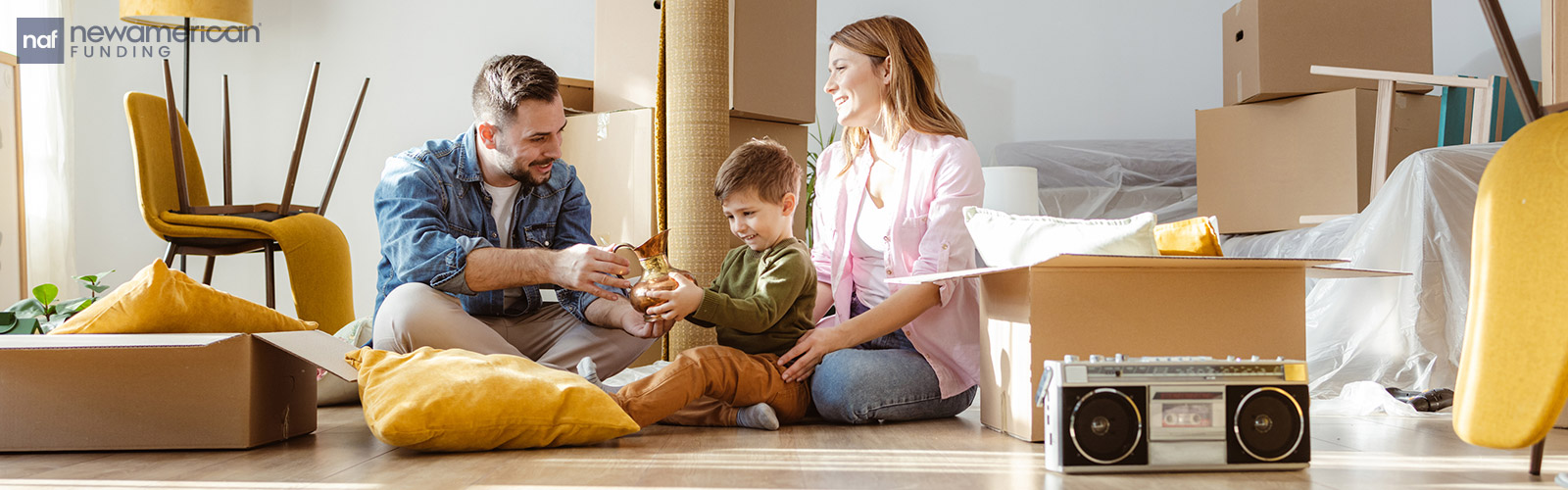 family sitting on the floor of their new house