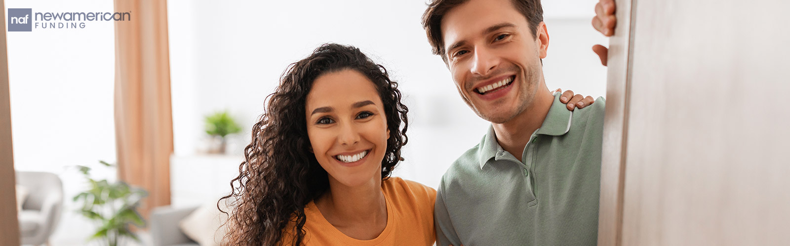 couple opening the door to their new home