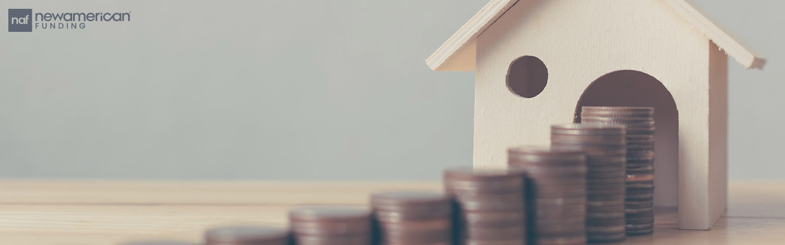 stack of coins leading to a model house