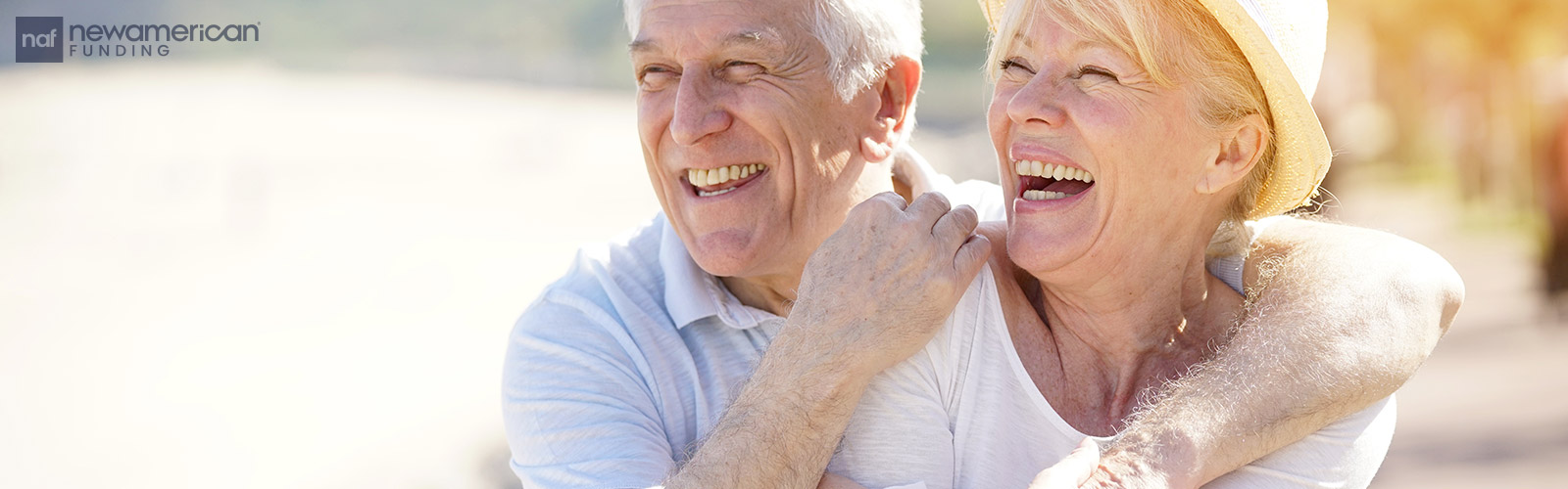 A senior white man and woman laugh together
