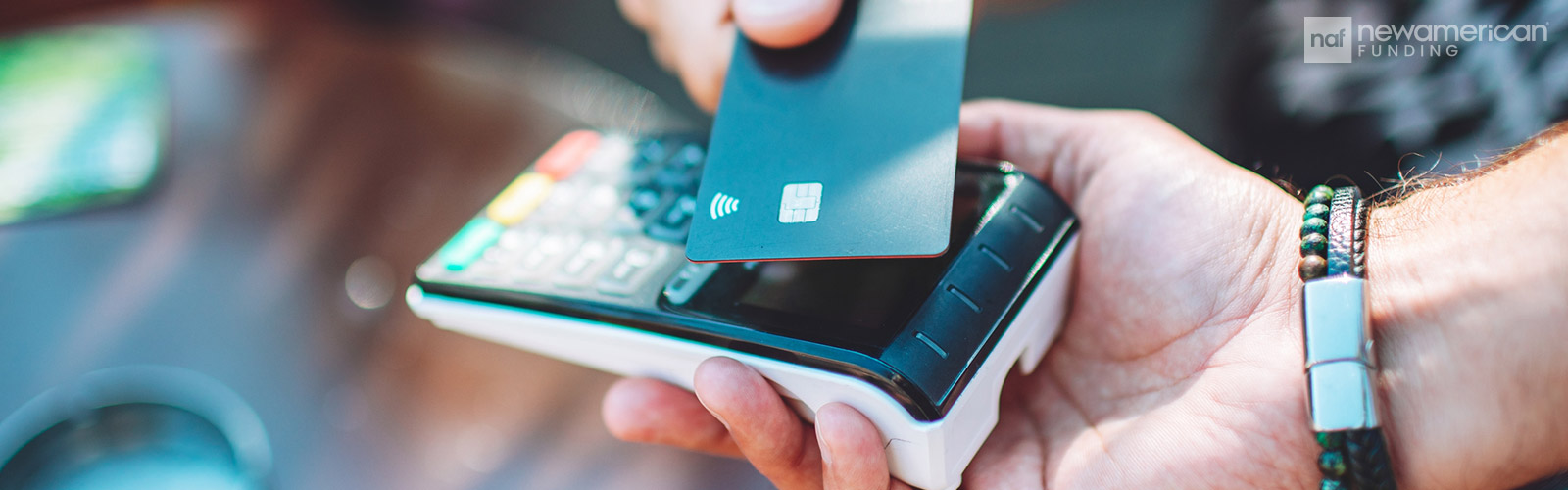 someone swiping their credit card for a purchase