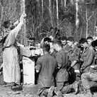 Army Chaplain (Maj.) Charles Watters elevates the host during a Holy Week liturgy for paratroopers of the 173rd Airborne Brigade in Vietnam in March 1967. (AP Photo/Horst Faas)