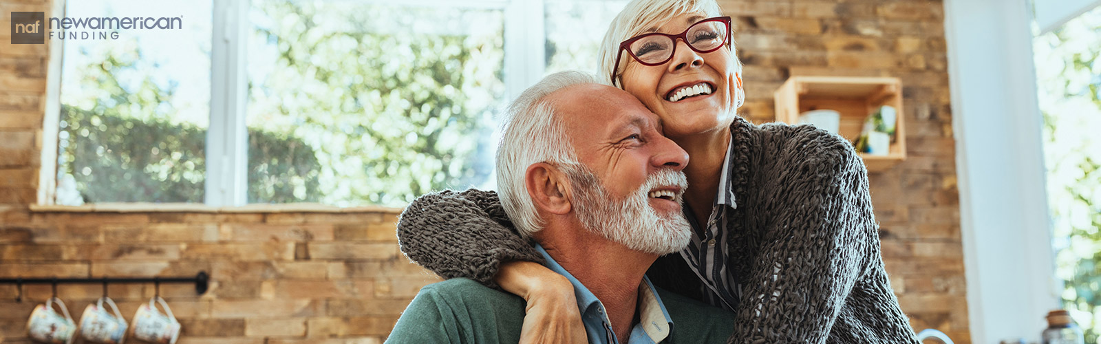 lovely senior couple hugging in the kitchen
