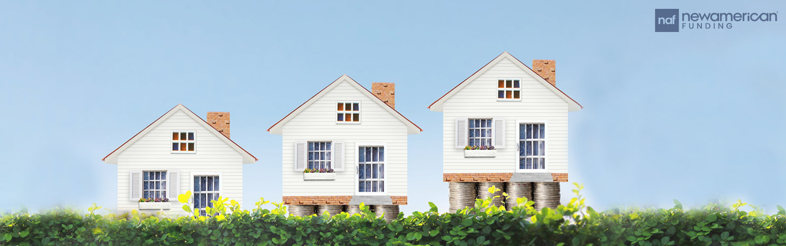 Three little house models stacked next to each other