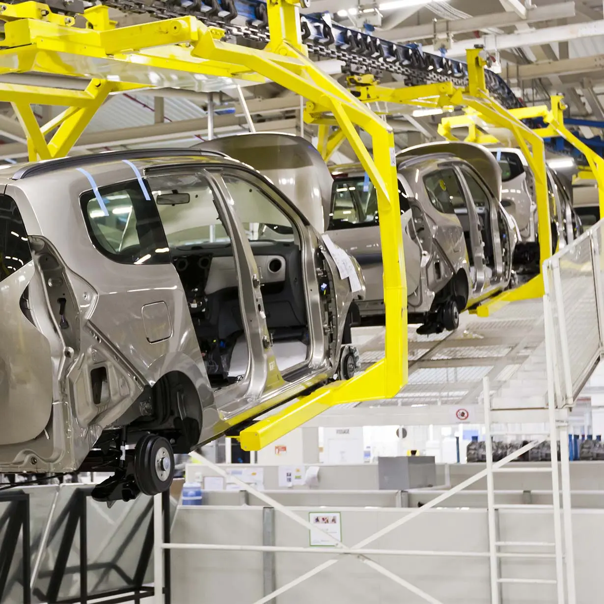 Production line of cars being assembled in a factory