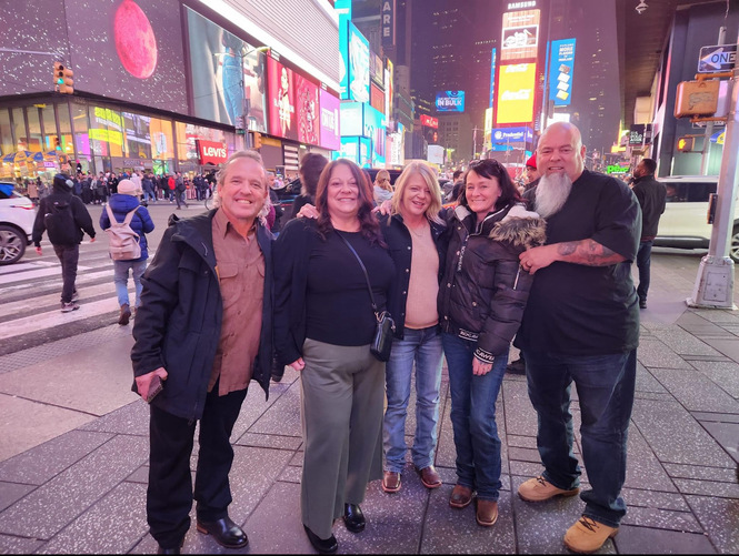 A group of people posing for a photoDescription automatically generated