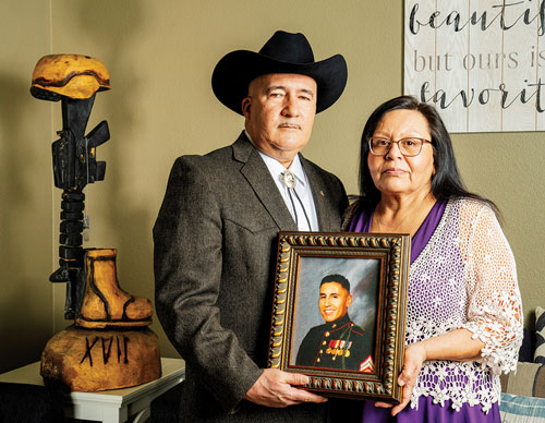 Adan and Yolanda Gonzales hold a portrait of their only son, Marine Sgt. Adan Gonzales Jr., who was killed during combat operations in Helmand Province, Afghanistan, on Aug. 7, 2011. (Photo by M. Scott Brauer)