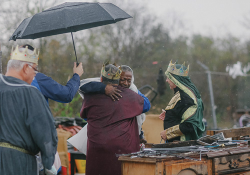 A resident of Camp Esperanza hugs Deacon Guerra after receiving a gift from the Posada participants.