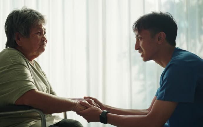 Nurse and patient holding hands