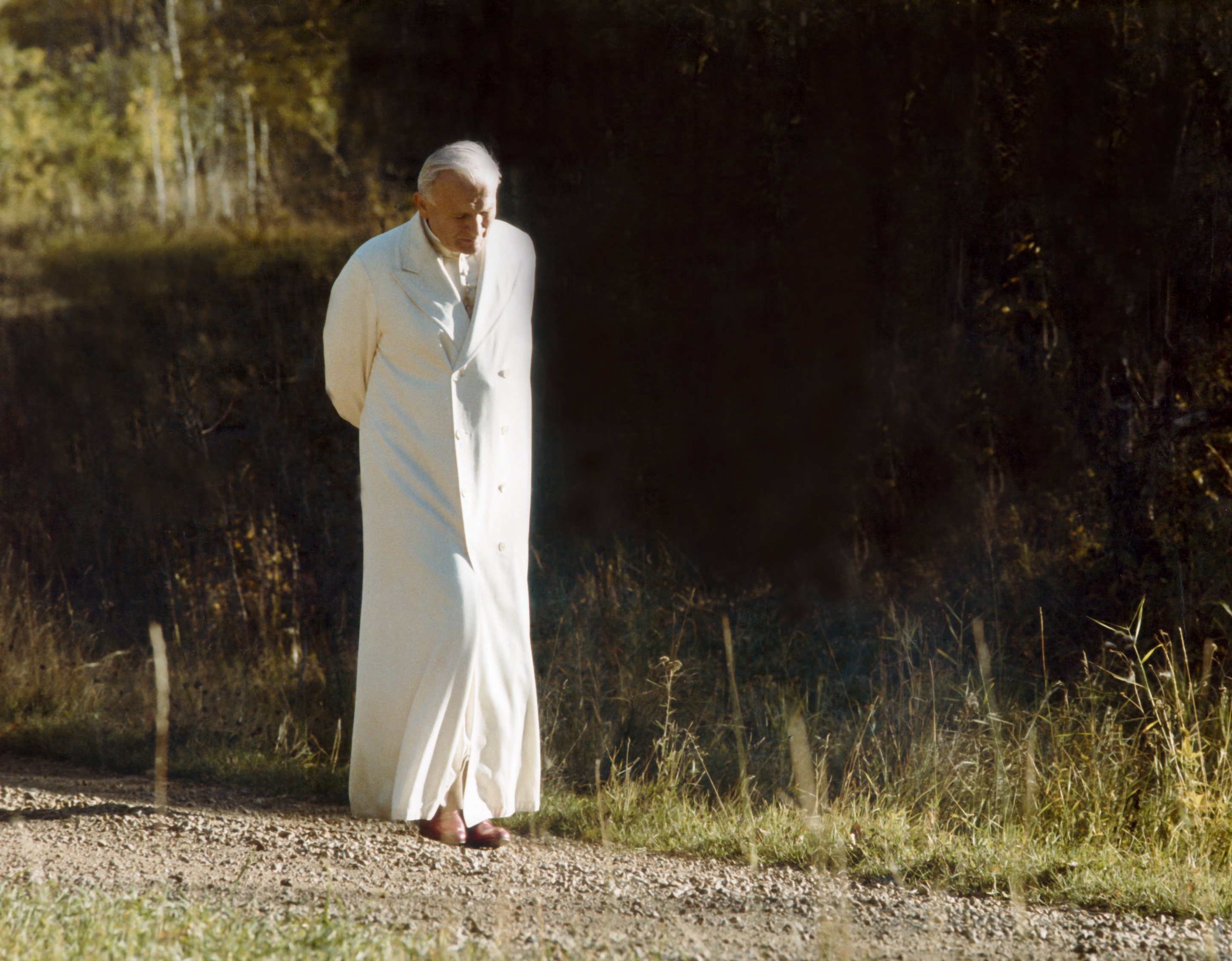 Pope John Paul II walks down a gravel path in an undated photo by Vatican photographer Arturo Mari. (CNS photo/L'Osservatore Romano)