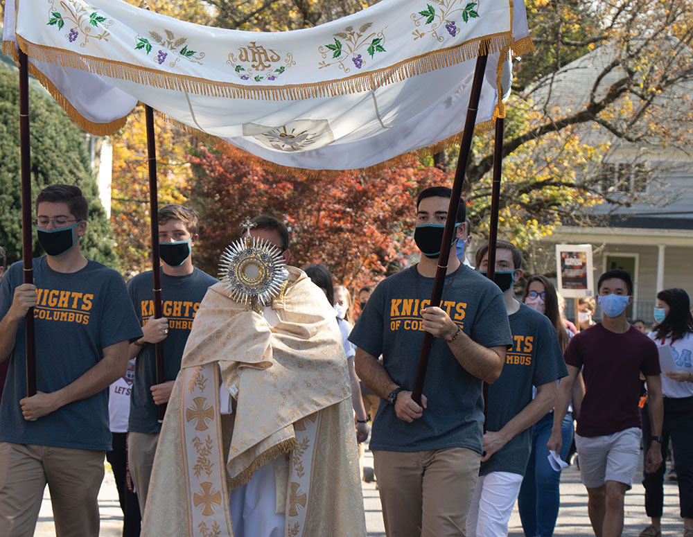 Grand Knight Nicholas Zaso (front right) and other members of St. John Henry Newman Council 11323 at Virginia Tech in Blacksburg, Va., lead a eucharistic procession and rosary on campus.