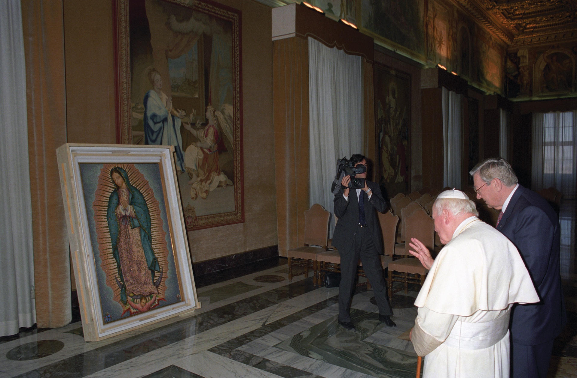 Pope John Paul II, flanked by Past Supreme Knight Virgil C. Dechant, blesses a mosaic of Our Lady of Guadalupe at the Vatican Oct. 10, 1998. 