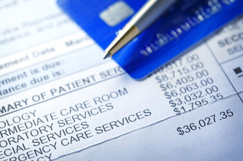 medical bill with credit card and pen