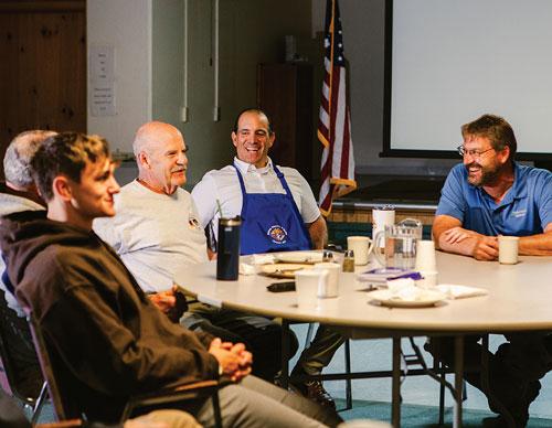 Christopher Lovera (center), grand knight of Bishop Maurice F. Burke Council 4031 in Cody, Wyo., shares a laugh with other members of the Cor group at St. Anthony of Padua Parish on June 4. (Photo by Tami Weingartner)