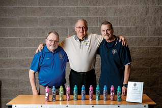 From left, Dave Spacht, Phil Legler and Greg Penco stand with just a few of the thousands of baby bottles that Knights in the area used to collect $109,000 for a mobile ultrasound unit.