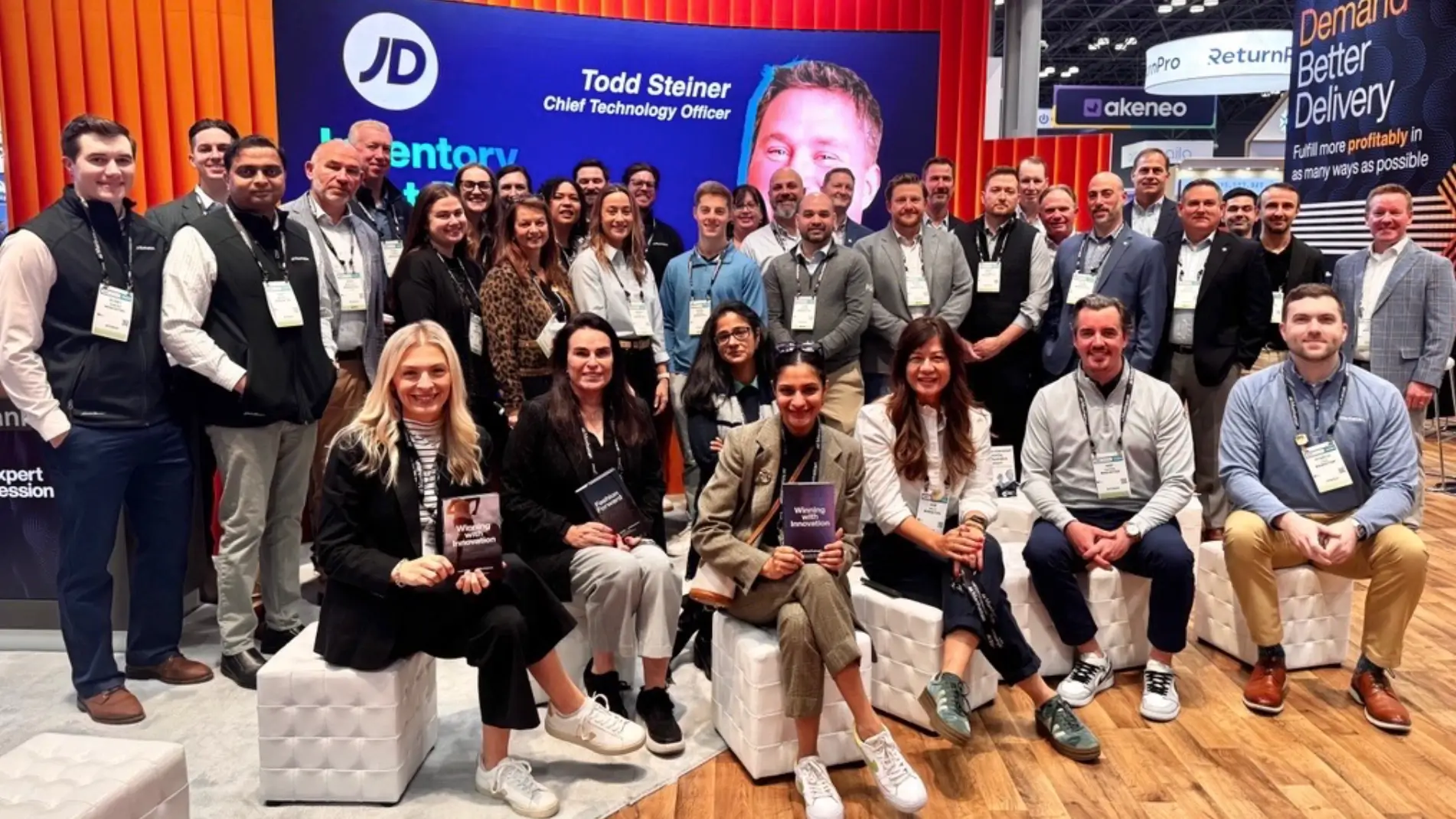 A wide group of Manhattan staff stood at the Manhattan exhibition booth at NRF 2026