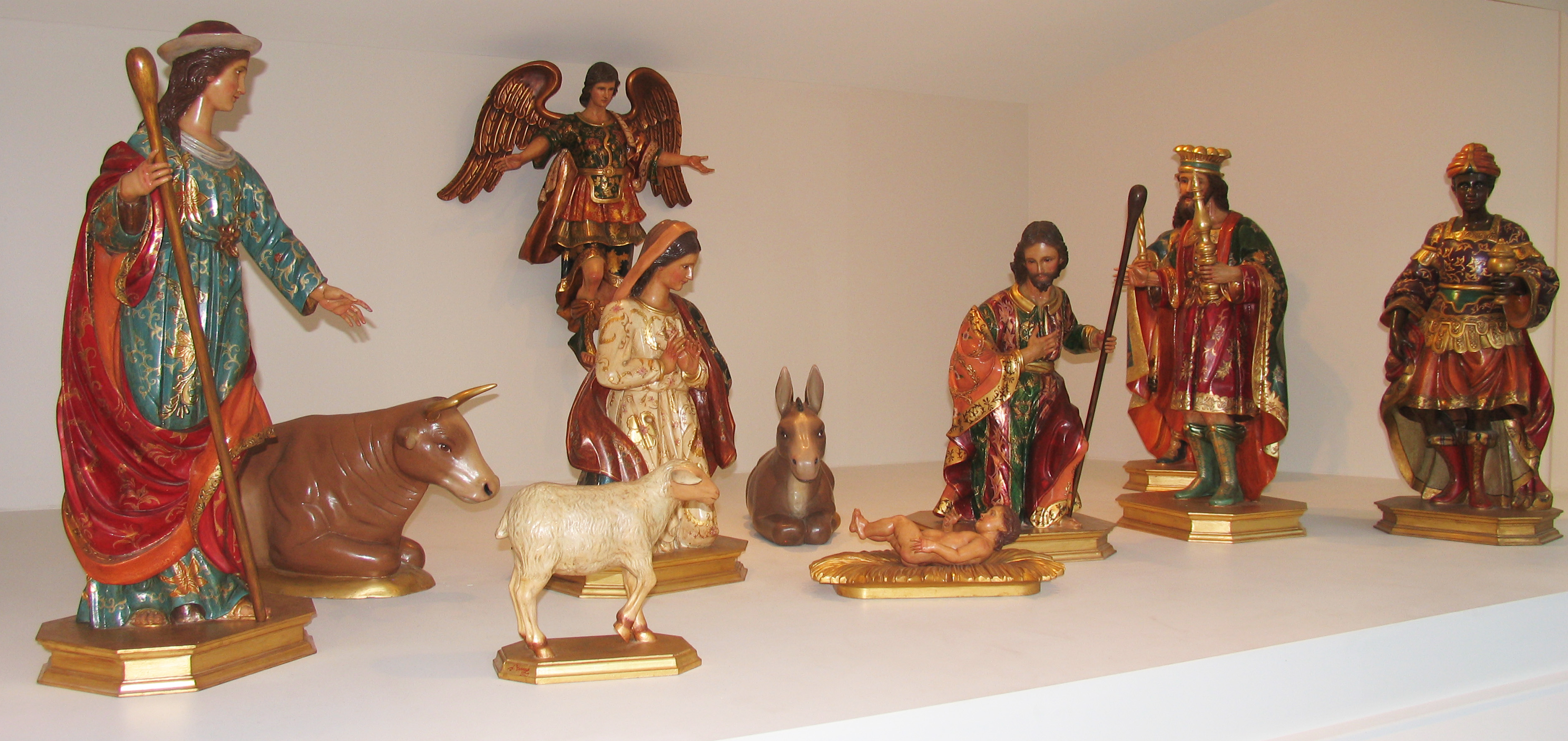 Wood painted Nativity with Holy Family, Angel, 3 Magi, 2 shepherds, a lamb, an ox, and a donkey.