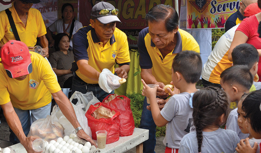 Knights from the Philippines provide food for families is need.