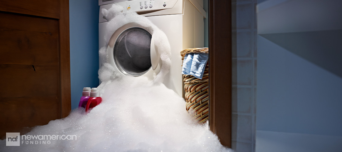 A washing machine spewing out soap bubbles.