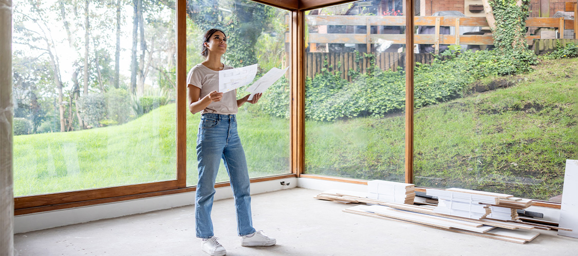 A homeowner looking at plans for renovating their home