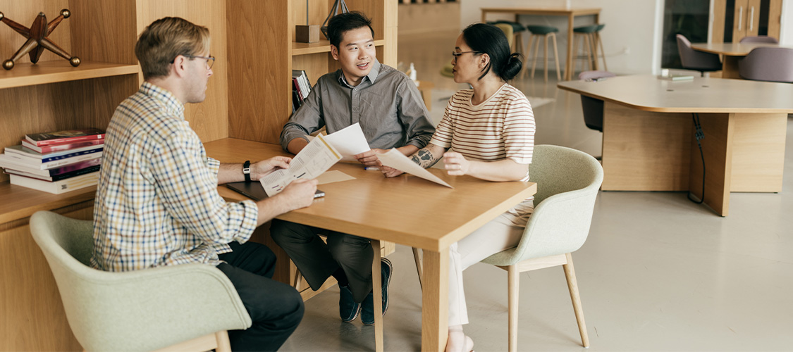 A couple meeting with a loan officer at an office.