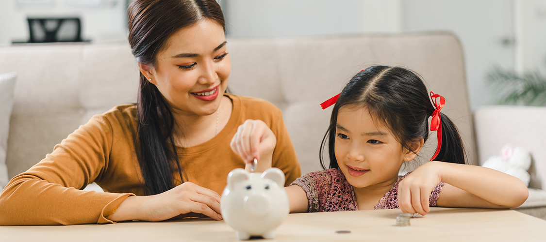 people putting money in a piggy bank