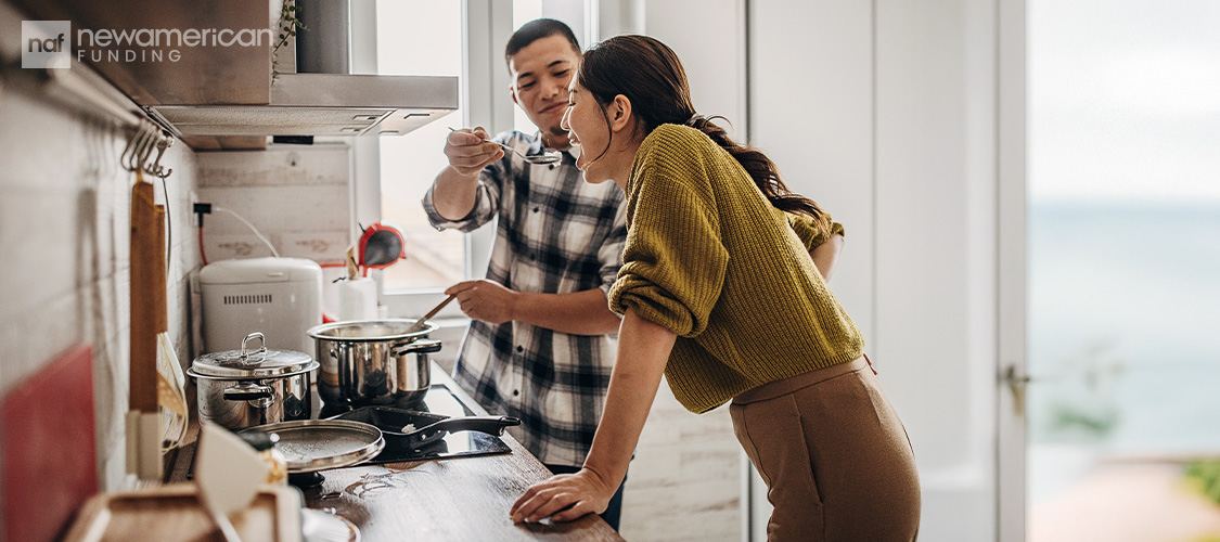 A couple cooking dinner together.