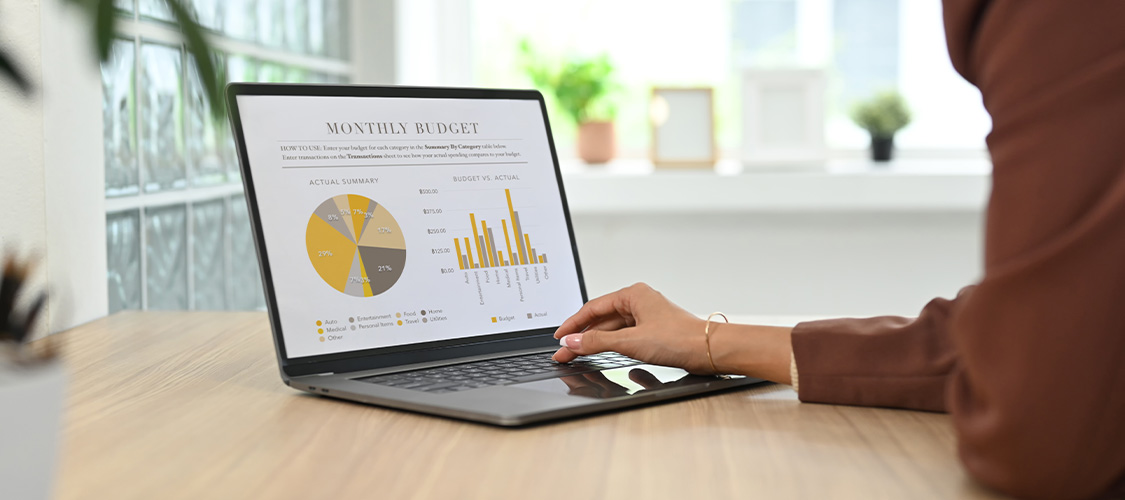 Someone reviewing financial information on a laptop