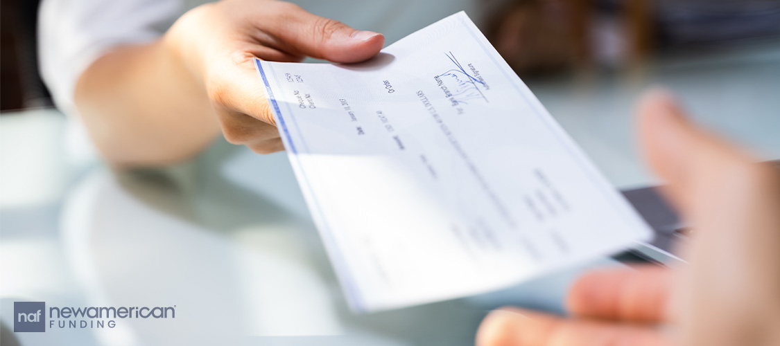 Someone handing over a check.