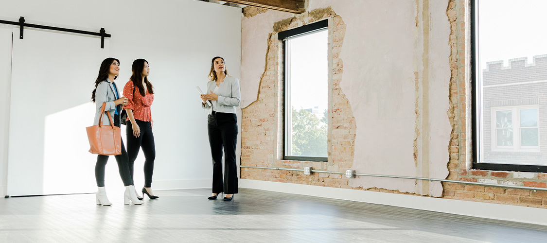 Homebuyers talking to a real estate agent