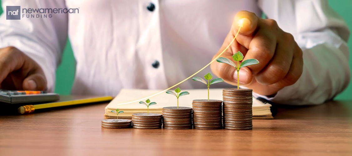 A row of stack of coins with shoots growing out of them.