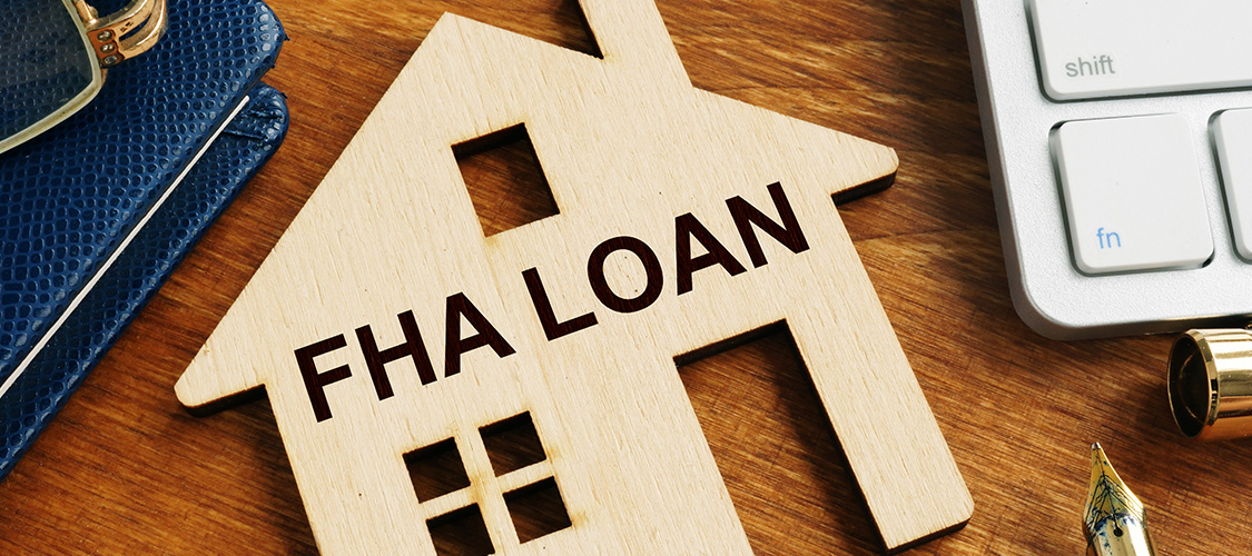 A wooden, house-shaped block that says