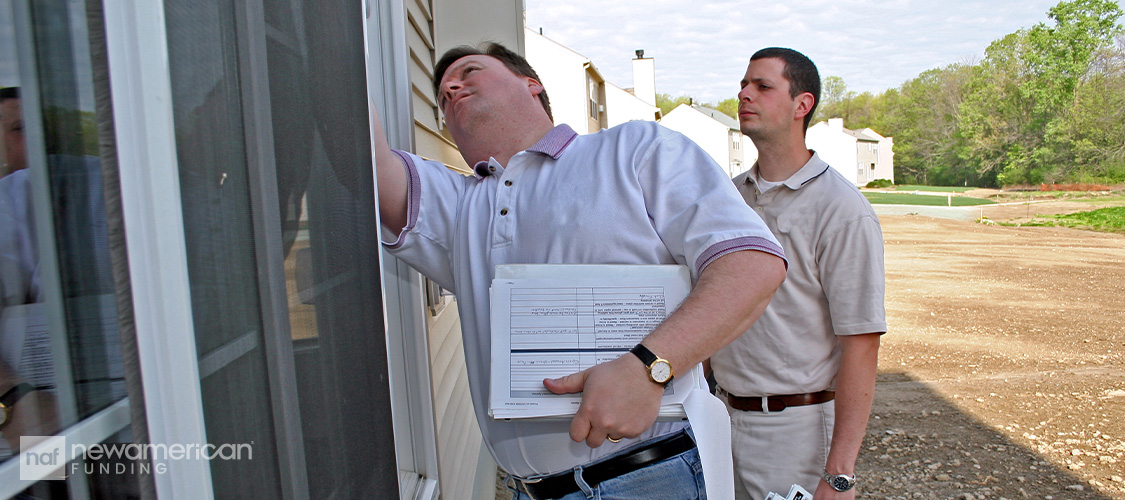 An appraiser or inspector examining a house.