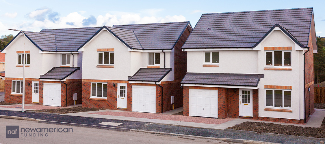 A row of identical, two-story, newly constructed homes.