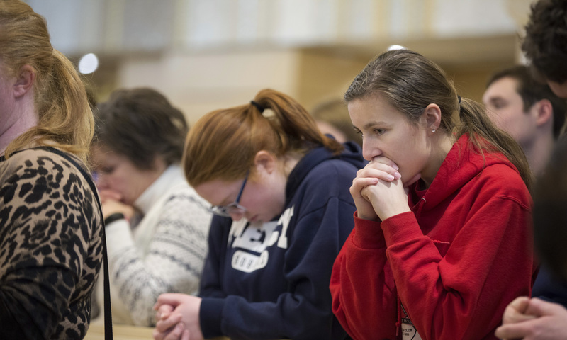 Pilgrims pray at the Redemptor Hominis Church in the JPII Shrine