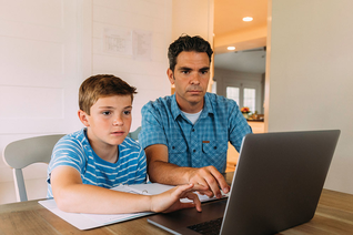 Father and son looking at a laptop