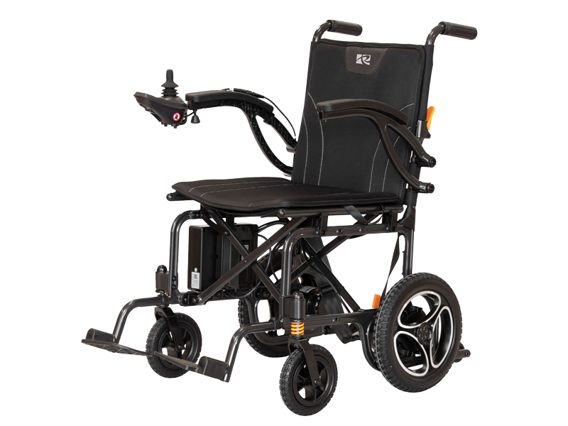 Roma Medical Athens powered wheelchair with lightweight black frame, padded seat and backrest, armrests and joystick control, rear push handles and compact wheels, shown on a white background.