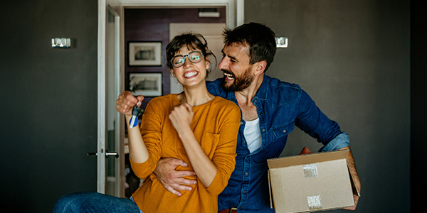 A happy couple moving into a home