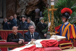 Supreme Chaplain Archbishop William Lori and Supreme Knight Patrick Kelly kneel in prayer before the body of Pope Benedict XVI in St. Peter’s Basilica on Jan. 3.