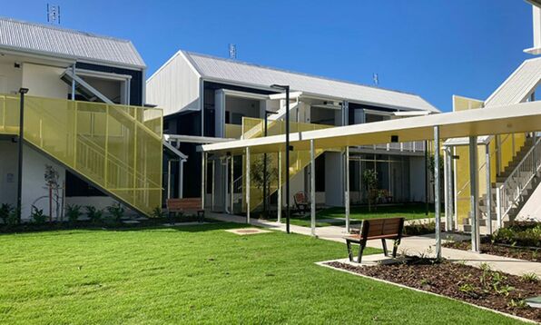Exterior view of Mission Australia's Townsville Youth Foyer with landscaped gardens and modern apartments.