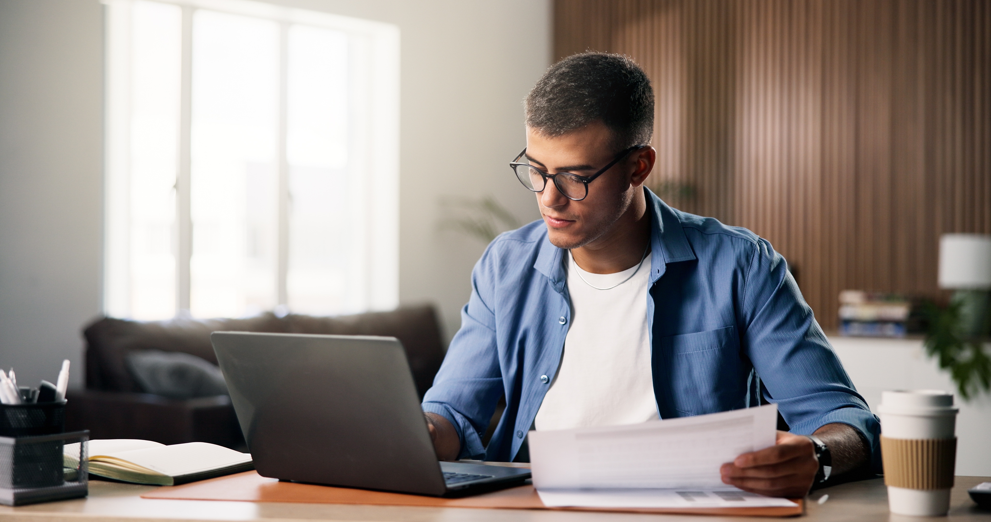 Man in home office working on a laptop