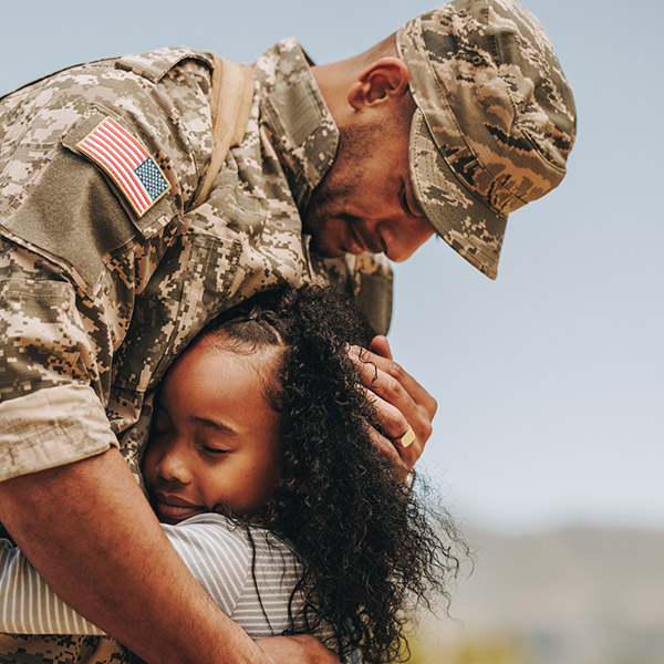 daughter hugging her military father