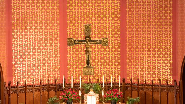Photo of St. Mary's Church interior with  Carolingian-style crucifix designed by Tommaso Gismondi suspended over altar.