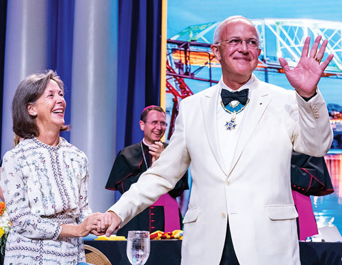 Past Supreme Knight Anderson, pictured with his wife, Dorian, acknowledges applause after being honored for his service to the Order and the Church
